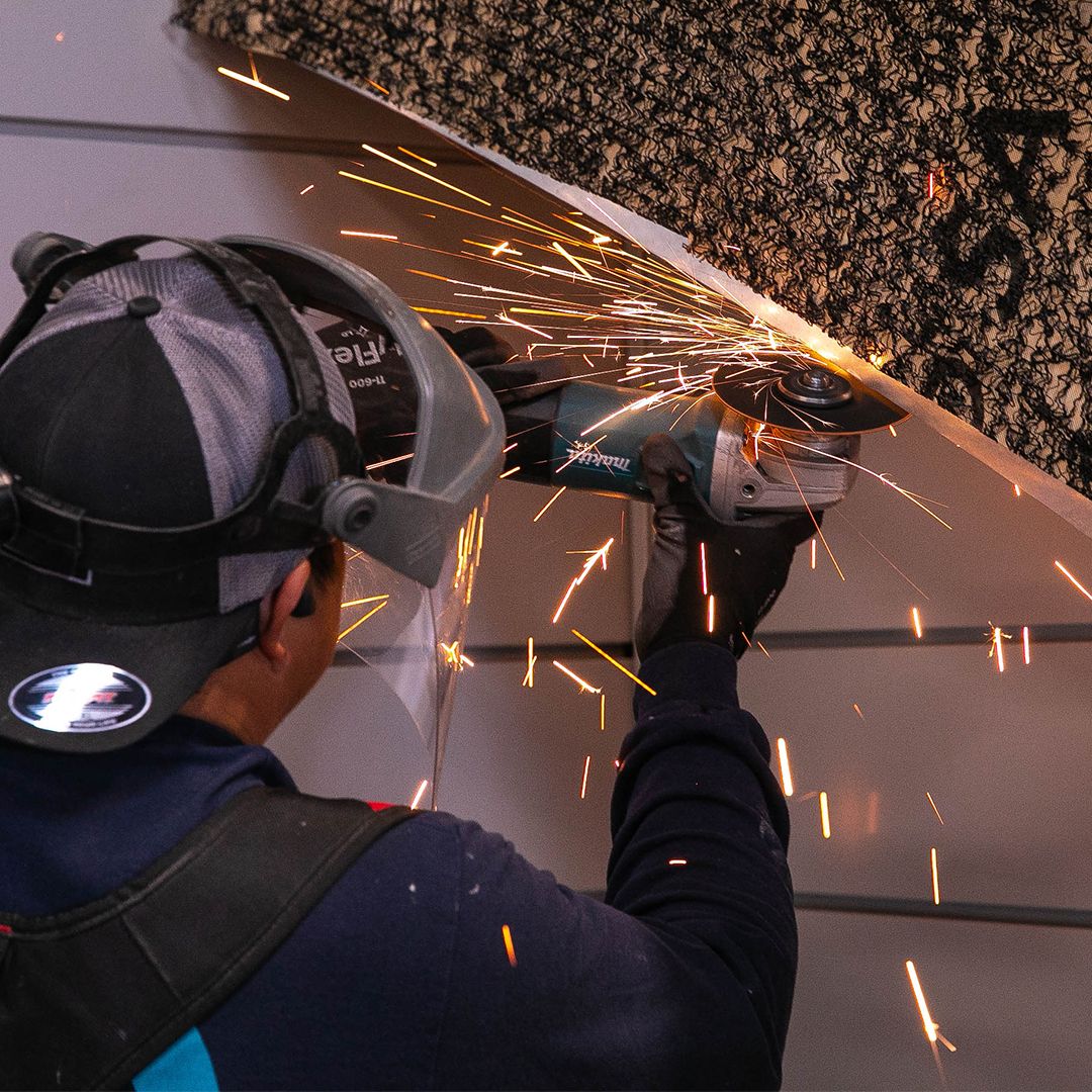 Sparks fly as a CMC fabricator cuts exterior panel steel inside the Springfield factory